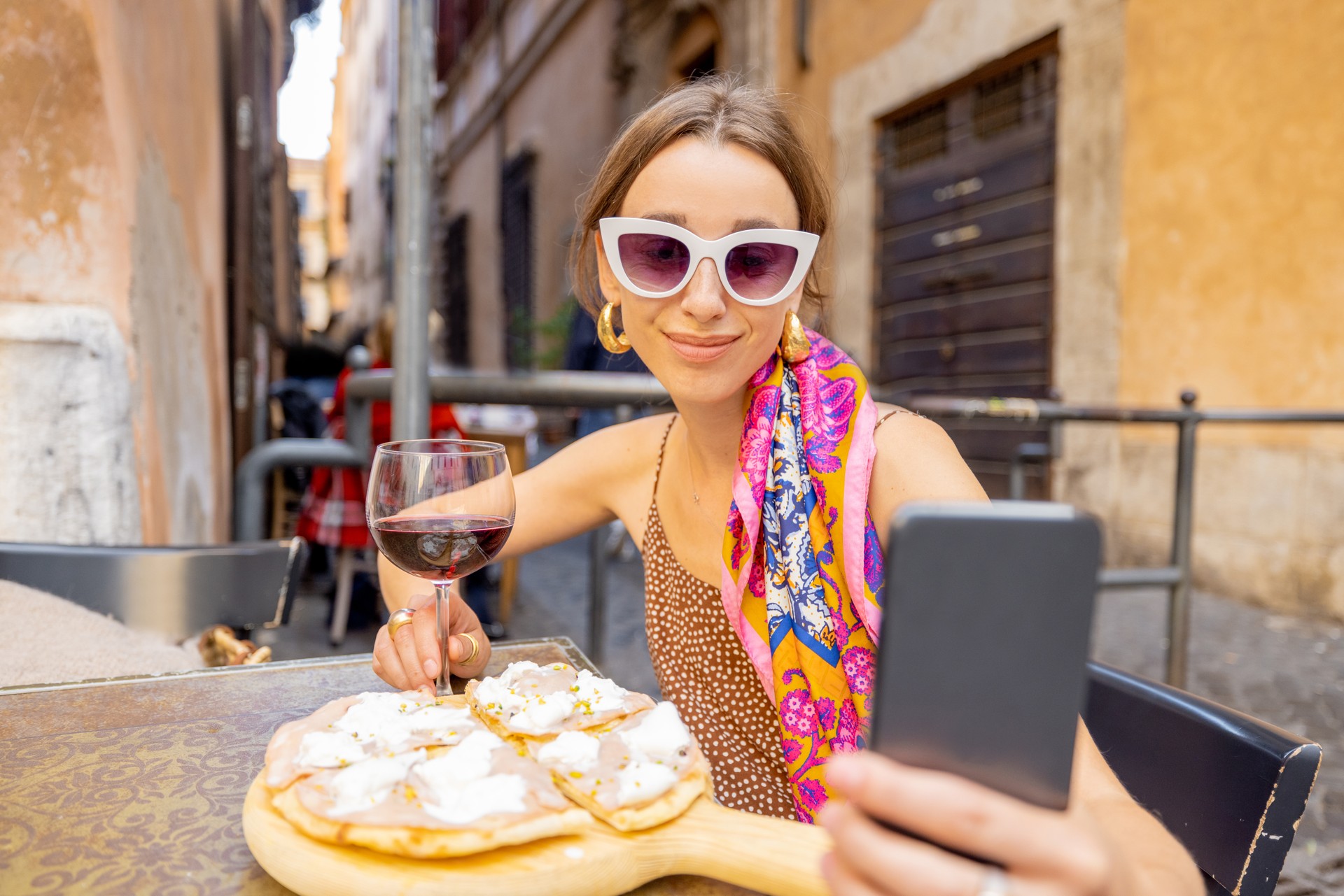 Woman eating pizza at italian restaurant outdoors